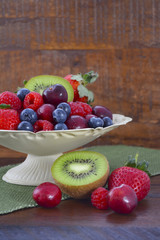 Summer Fruit in Vintage Bowl on Dark Wood Table.