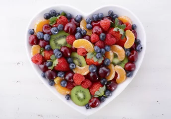 Zelfklevend Fotobehang Colorful rainbow fruit in heart shape bowl. © millefloreimages