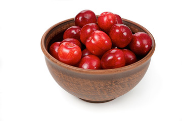 red cherries in a bowl on a white background