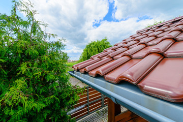 Tiled Roof Of Wooden Arbor against blue cloudy sky background