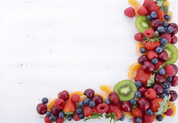Fresh organic wholesome fruit on white wood table.