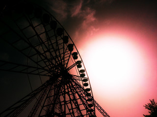Silhouette of a Ferris wheel on a background of red sky.
Illustration of a horror movie.