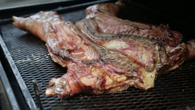 Whole southern pig being grilled slowly on the outdoor cooker