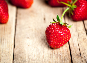 Fresh strawberries on a wooden background. fruit