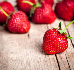 Fresh strawberries on a wooden background. fruit