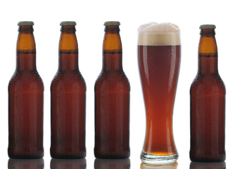 Four Brown Beer Bottles and Full Glass