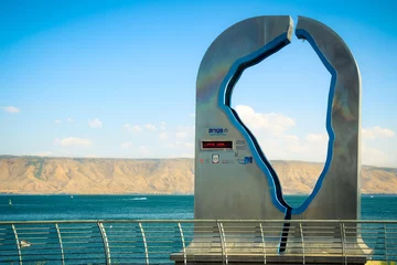 Zelfklevend Fotobehang Tiberias, Israel - September 28, 2013: A metal sculpture of the Sea of Galilee, of the company Mekorot.  A "Performance gauge" that measures the water level is digitally at any time. © wavemovies