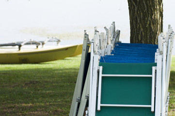 empty sunbeds in line at the lake.