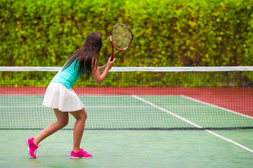 Fototapeta na wymiar Young active woman playing tennis on tropical vacation