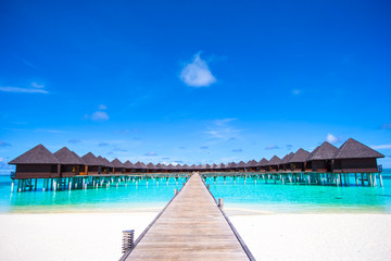 Obraz na płótnie Canvas Water bungalows and wooden jetty on Maldives