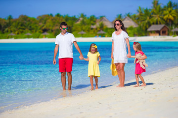 Happy beautiful family on a tropical beach holiday