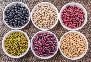Beans variety in white bowl on in wicker tray