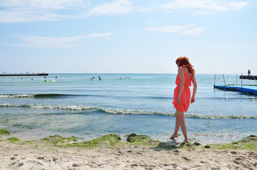 Red-haired girl near the sea