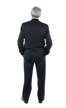 Businessman with hands in pocket from behind