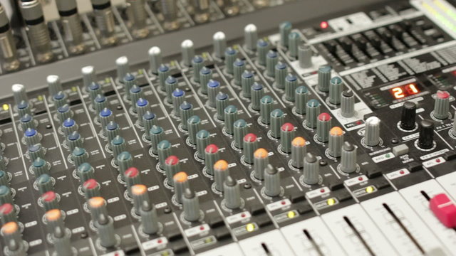 A studio mixing desk pan across