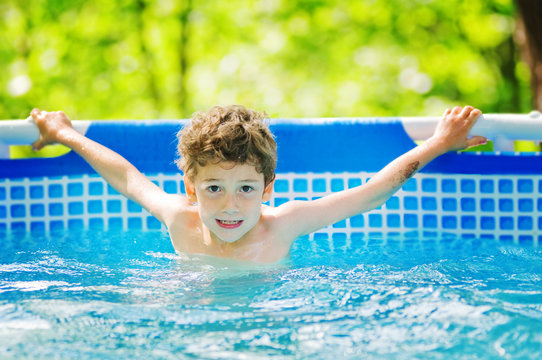 little boy swimming in an outdoor pool
