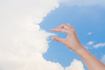 Hand holding clouds.