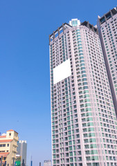 blank billboard on building in city view background