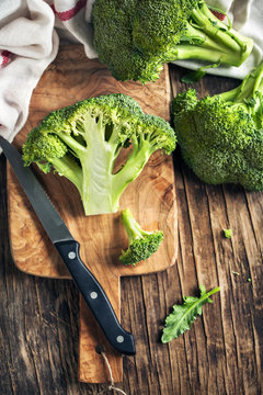 Fresh broccoli on wooden cooking board