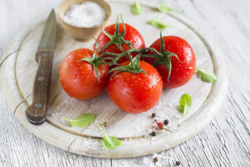 fresh tomatoes on a light wooden background