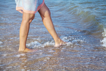 Woman walking on the sea beach