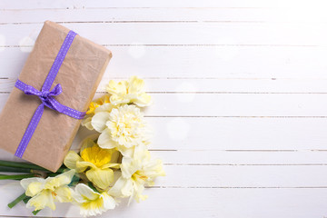 Spring flowers narcissus and box with present