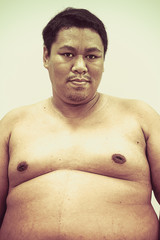Naklejka premium Fat naked upper body belly stomach of Asian African man isolated