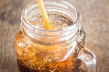 Refreshing brown soda with ice
