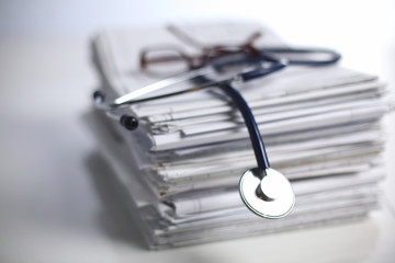 Medical stethoscope on the stack of paper