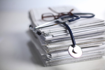 Medical stethoscope on the stack of paper