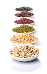Beans variety in white bowl over white background