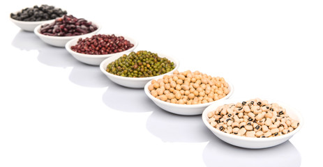Beans variety in white bowl over white background