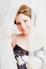 Close up of smiling woman in silk lingerie © OlgaKhorkova