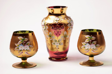 red and gold ornate glass vase and vine goblet glasses
