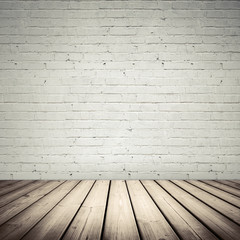 White interior with wooden floor and brick wall