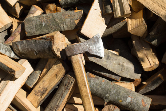 Axe on top of pile of chopped fire wood