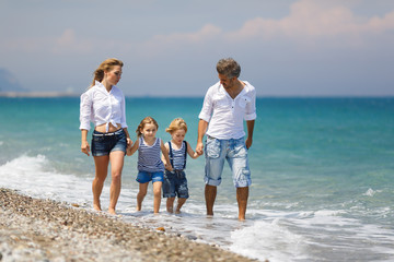 Family with two kids on the beach