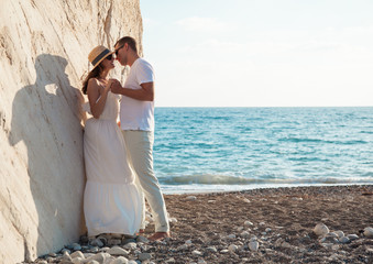 Young couple near the rock on the seacoast