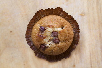 Chocolate chip muffin, slightly unwrapped or opened

