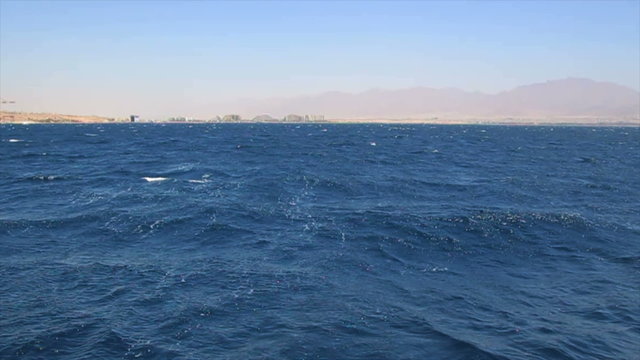 The Gulf of Eilat - A view from a moving ship of the coast of Eilat (Red Sea). The hotels area in sight.