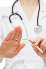 Doctor's hands showing disabling gesture and holding a cigarette