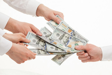 Business people taking money from businessman's hand