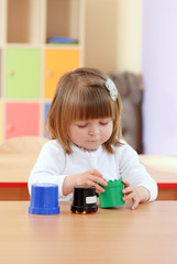 Two-year girl playing and learning in preschool