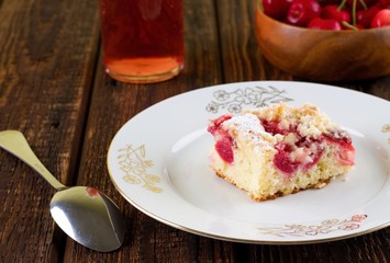 Cherry pie on white plate placed on wooden board