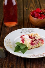 Sweet cherry pie with herb leaves on white plate