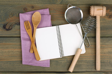 wooden kitchen tools and notebook on the table