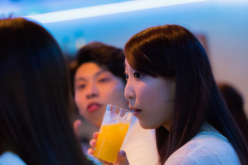 カウンターでお酒を飲む若者   © Taku