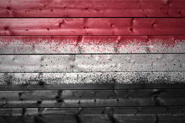 painted yemeni flag on a wooden texture