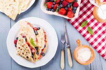 Delicious pancakes with raspberries, blueberries and strawberrie