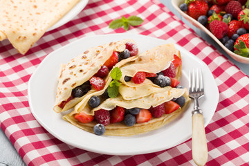 Delicious pancakes with raspberries, blueberries and strawberrie